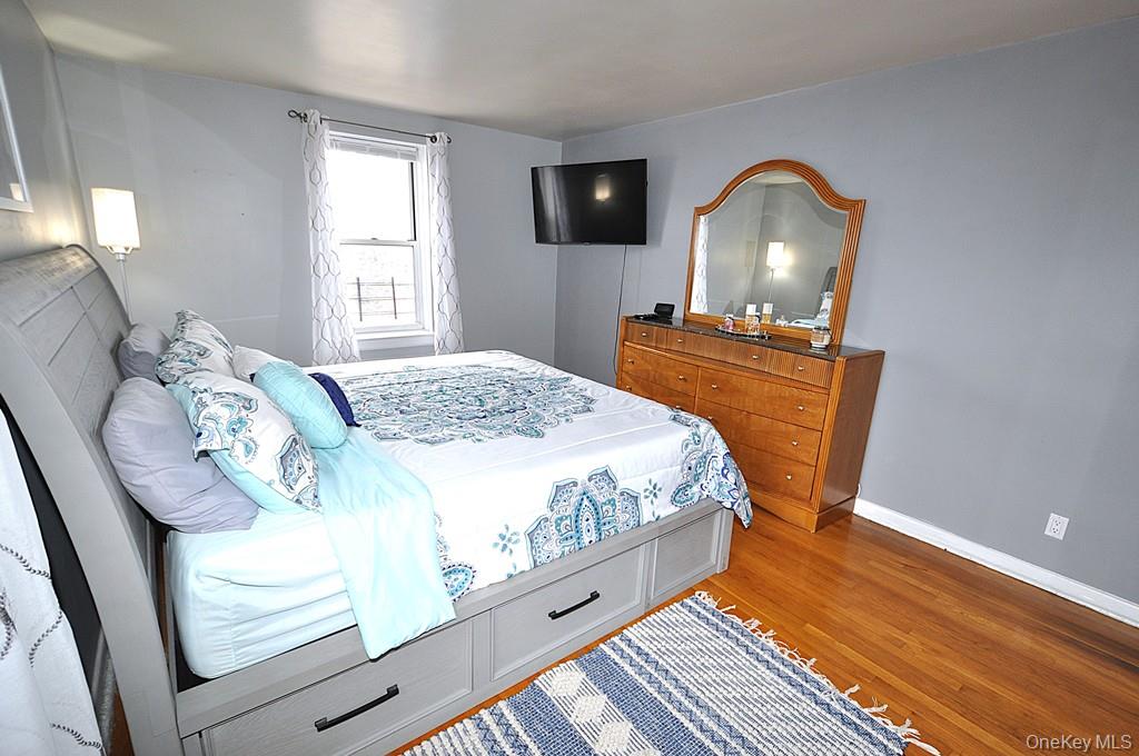 1 Vincent Road, Unit 6B Bronxville, NY 10708 - Photo 17 of 28 a bedroom with a bed and wooden floor