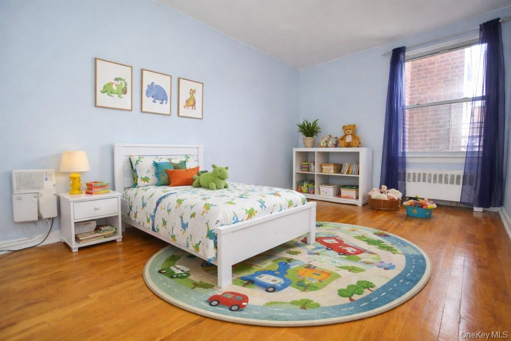 1 Vincent Road, Unit 6B Bronxville, NY 10708 - Photo 21 of 28 a bedroom with a bed and wooden floor