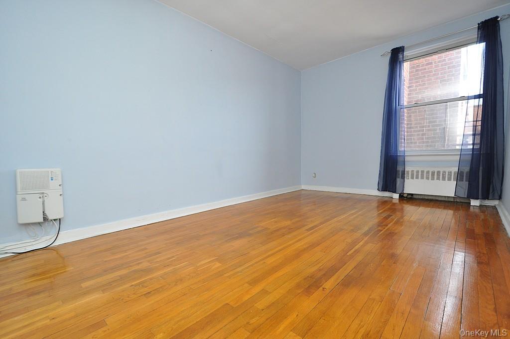 1 Vincent Road, Unit 6B Bronxville, NY 10708 - Photo 22 of 28 an empty room with wooden floor and windows