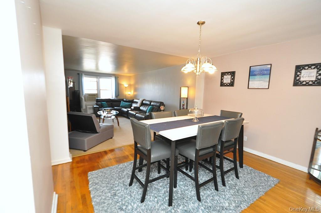1 Vincent Road, Unit 6B Bronxville, NY 10708 - Photo 10 of 28 a dining room with furniture a chandelier a rug and a window