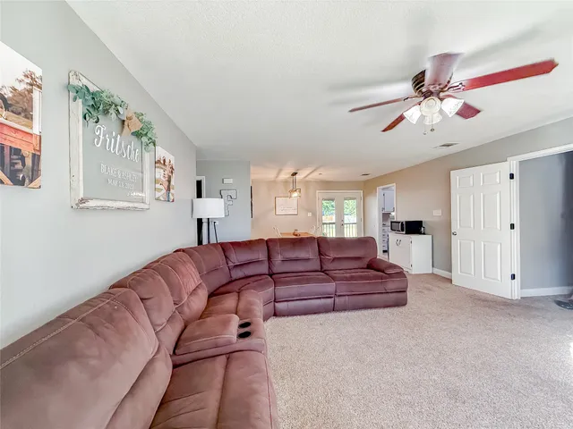 a living room with furniture and a chandelier