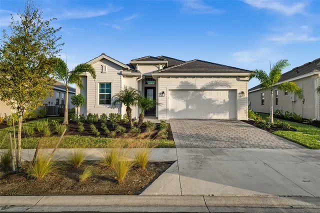 a front view of a house with a yard and garage