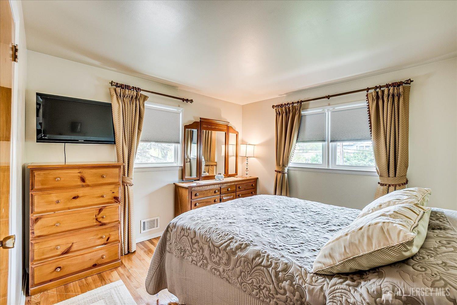 807 New Dover Road Edison, NJ 08820 - Photo 23 of 41 a bedroom with a bed and flat screen tv