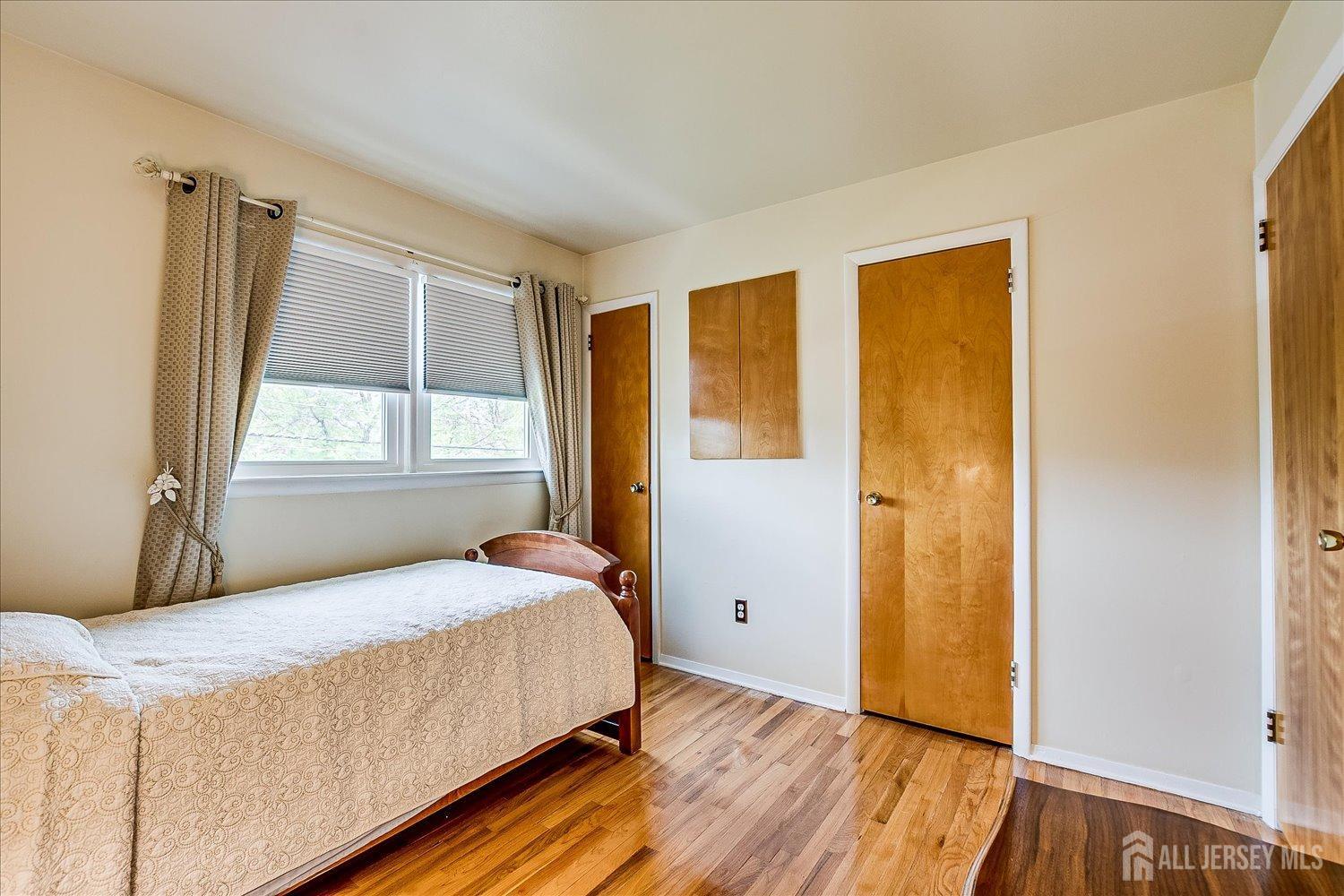 807 New Dover Road Edison, NJ 08820 - Photo 26 of 41 a bedroom with a bed and a window