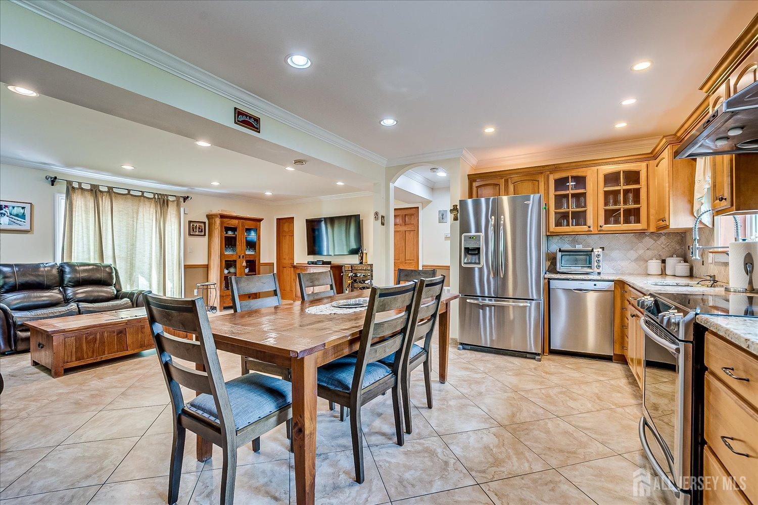 807 New Dover Road Edison, NJ 08820 - Photo 33 of 41 a kitchen with stainless steel appliances kitchen island granite countertop a table chairs sink and cabinets