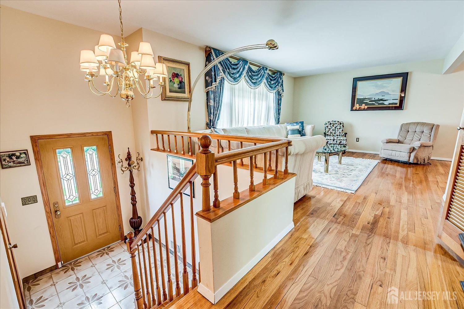 807 New Dover Road Edison, NJ 08820 - Photo 8 of 41 a view of entryway livingroom and hall with wooden floor