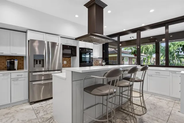 a bedroom with a bed and a flat screen tv in white walls