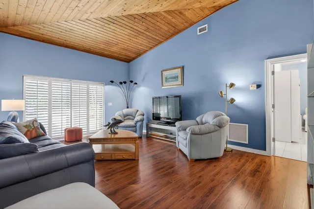 a view of a house with a big yard and a large trees