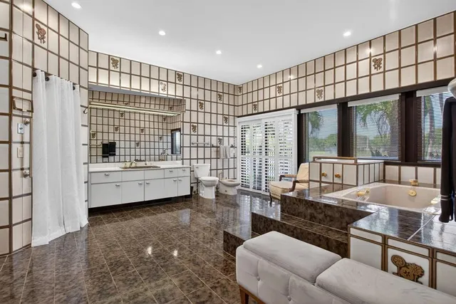 an aerial view of residential houses with outdoor space and lake view