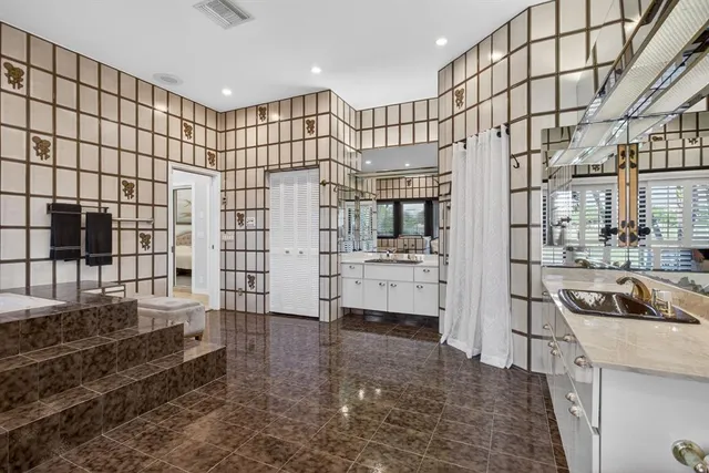 an aerial view of residential houses with outdoor space and lake view