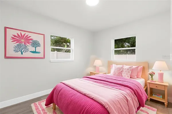 a bedroom with a bed and a painting on the wall