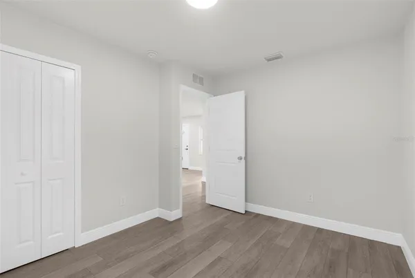 a view of an empty room and wooden floor