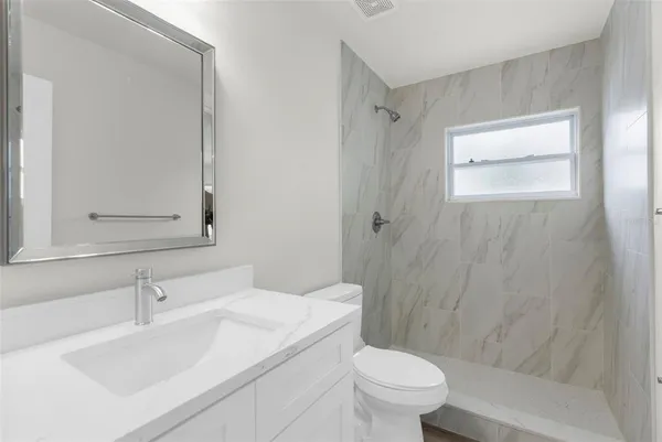 a bathroom with a sink toilet and shower