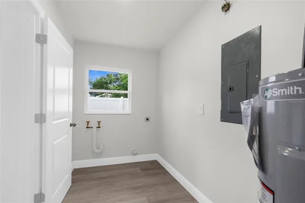 a view of room with window and wooden floor
