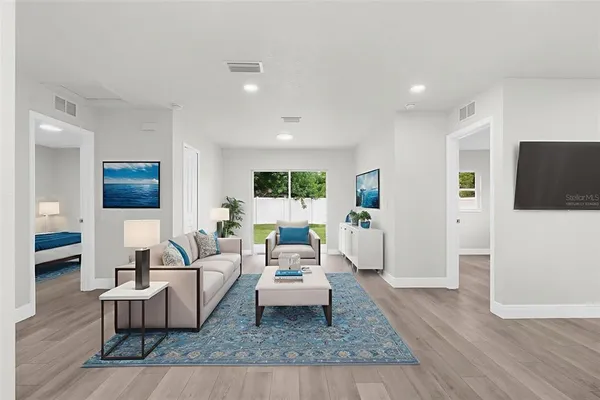 a living room with furniture and a flat screen tv
