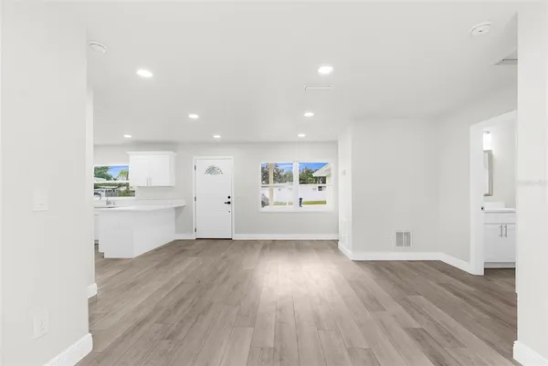 a view of a kitchen with wooden floor