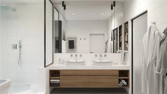 a bathroom with a sink a mirror a vanity and shower