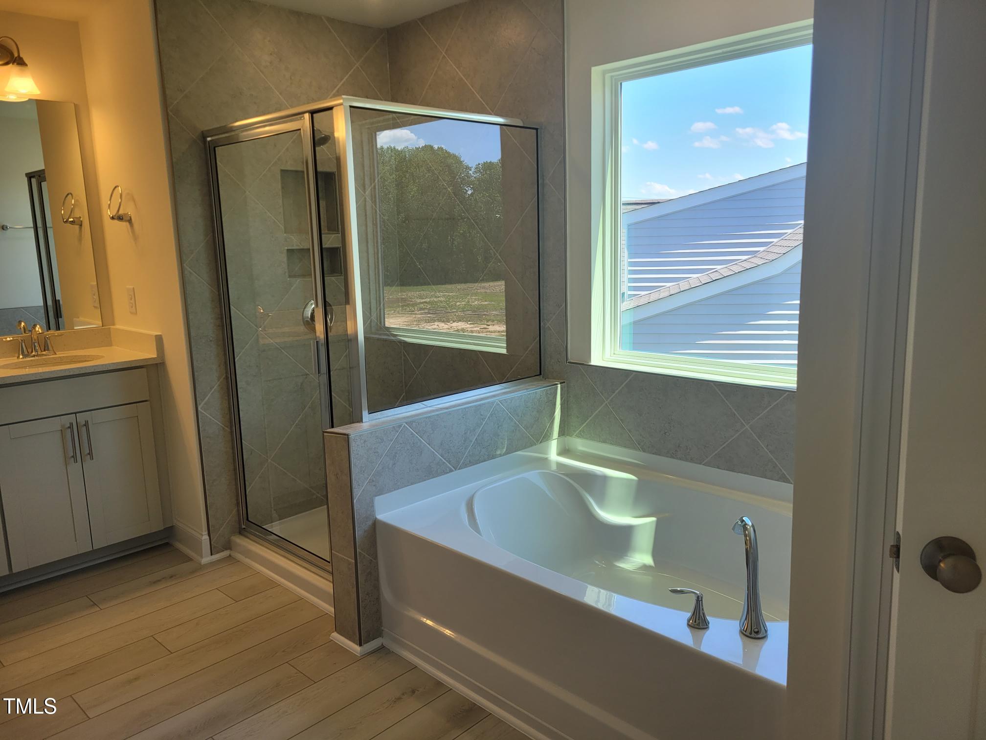 3703 Cessna Way, Unit 9 Wilson, NC 27896 - Photo 14 of 16 a bathroom with a tub and a sink