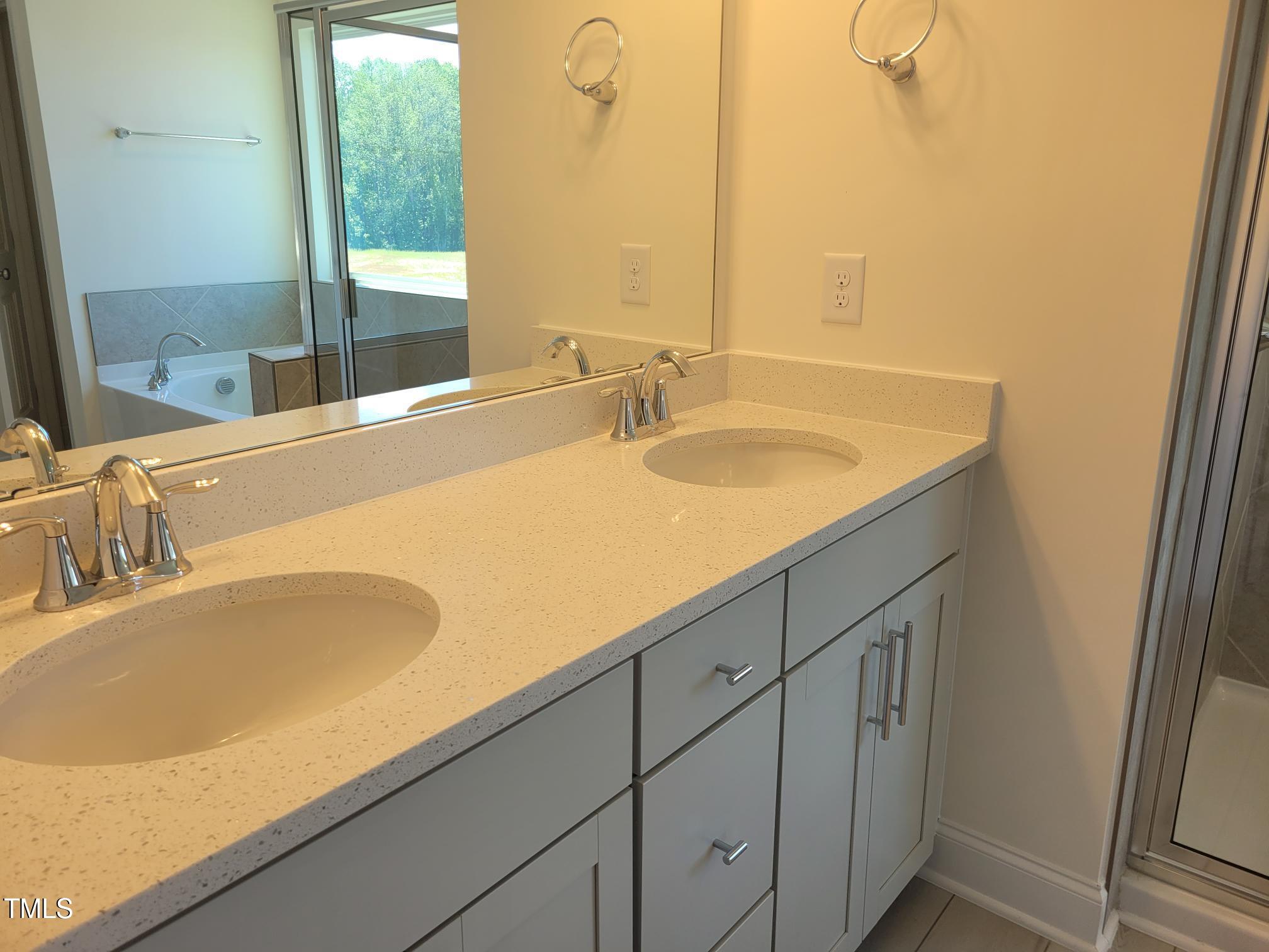 3703 Cessna Way, Unit 9 Wilson, NC 27896 - Photo 15 of 16 a bathroom with a granite countertop sink and a large mirror