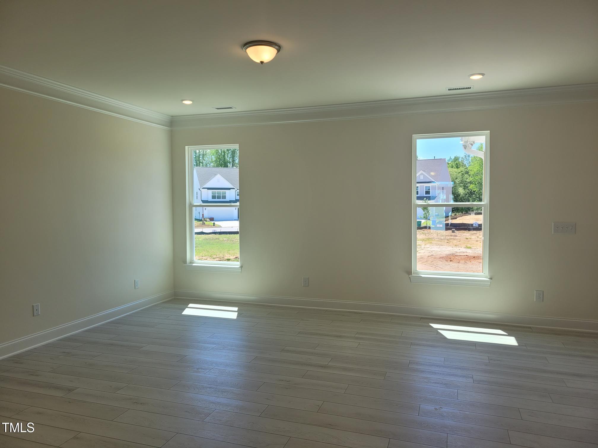 3703 Cessna Way, Unit 9 Wilson, NC 27896 - Photo 3 of 16 an empty room with wooden floor and windows