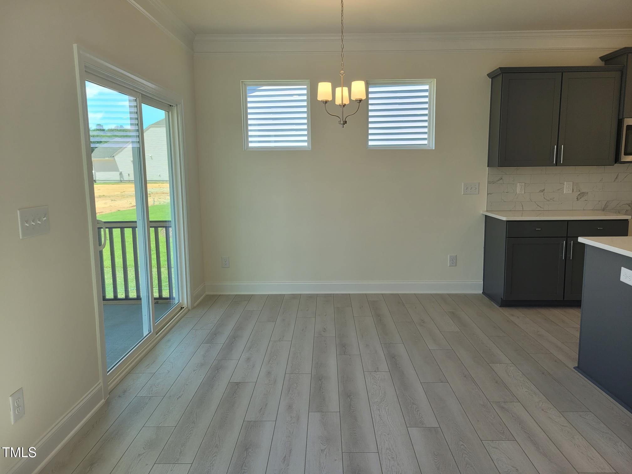 3703 Cessna Way, Unit 9 Wilson, NC 27896 - Photo 5 of 16 a view of an empty room with a window and wooden floor