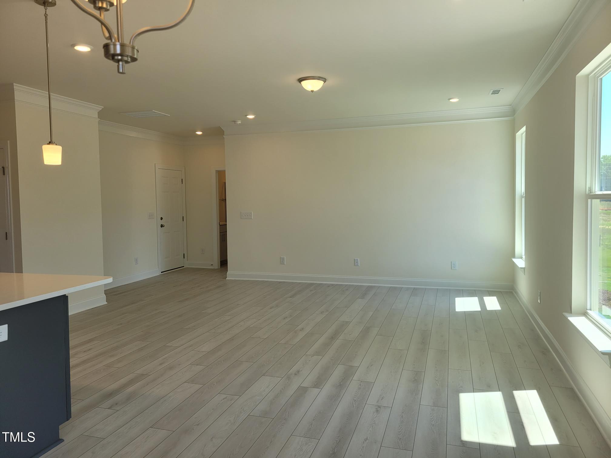 3703 Cessna Way, Unit 9 Wilson, NC 27896 - Photo 6 of 16 an empty room with wooden floor and windows