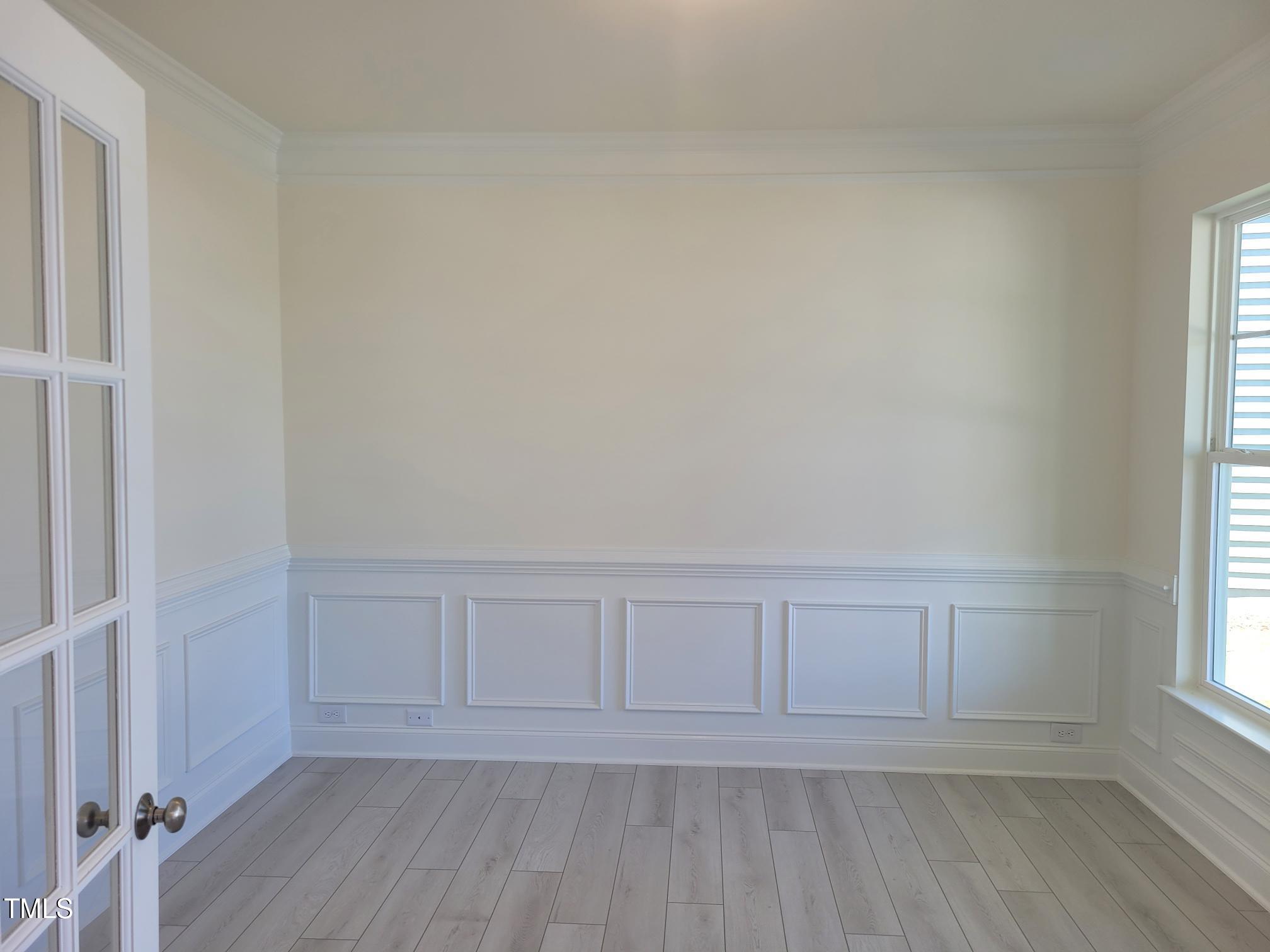 3703 Cessna Way, Unit 9 Wilson, NC 27896 - Photo 9 of 16 an empty room with wooden floor and windows