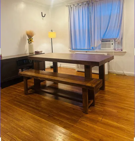 a view of a room with wooden floor and furniture