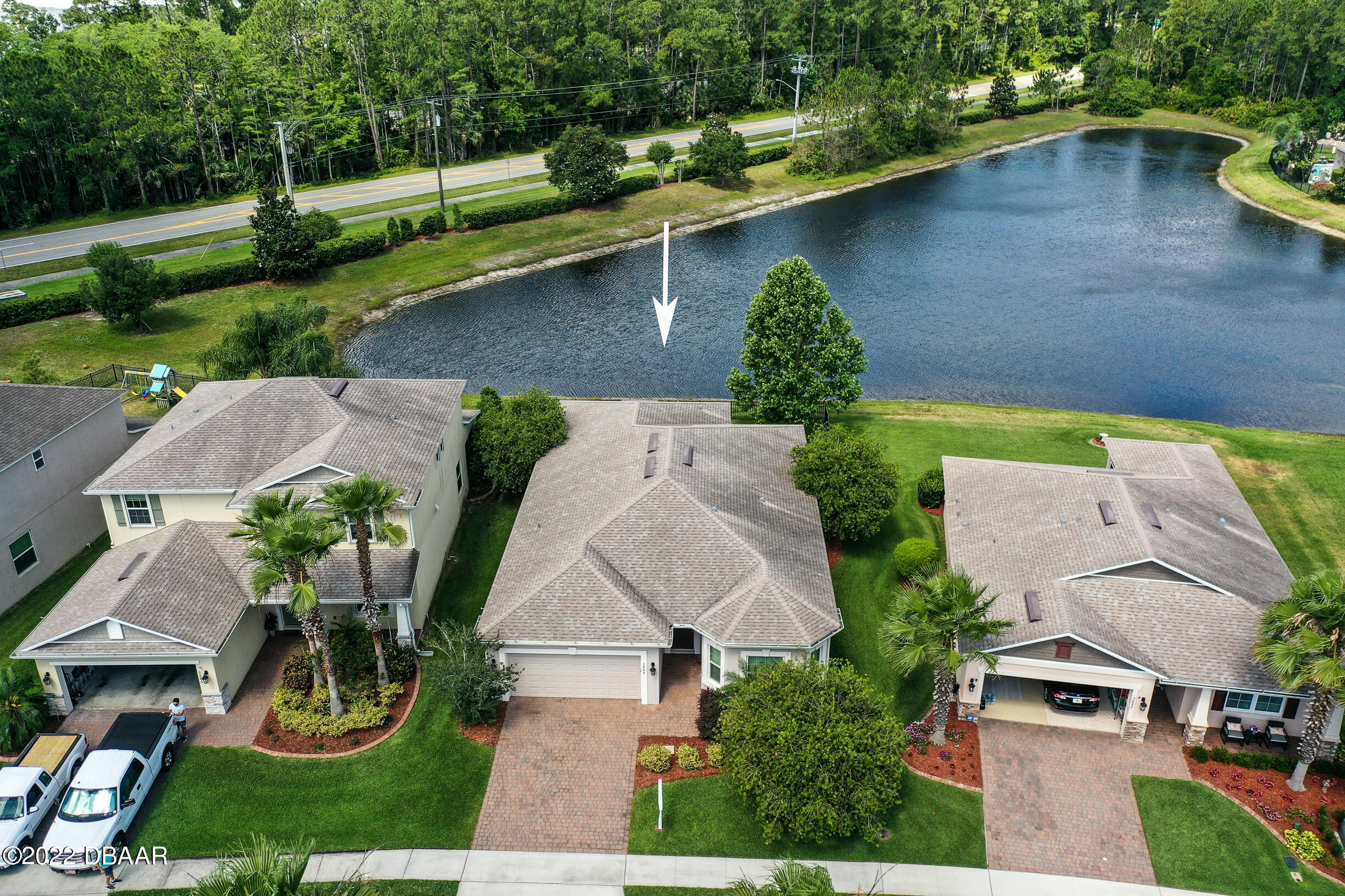 an aerial view of a house with a yard and a fountain