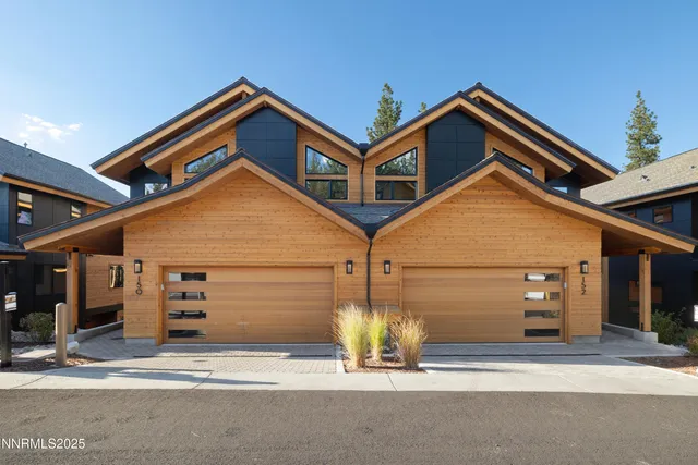 a view of a hallway with furniture and floor to ceiling window