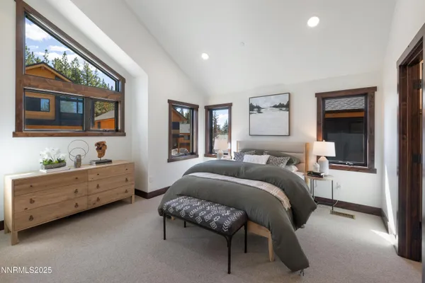 a bedroom with a bed and a large window