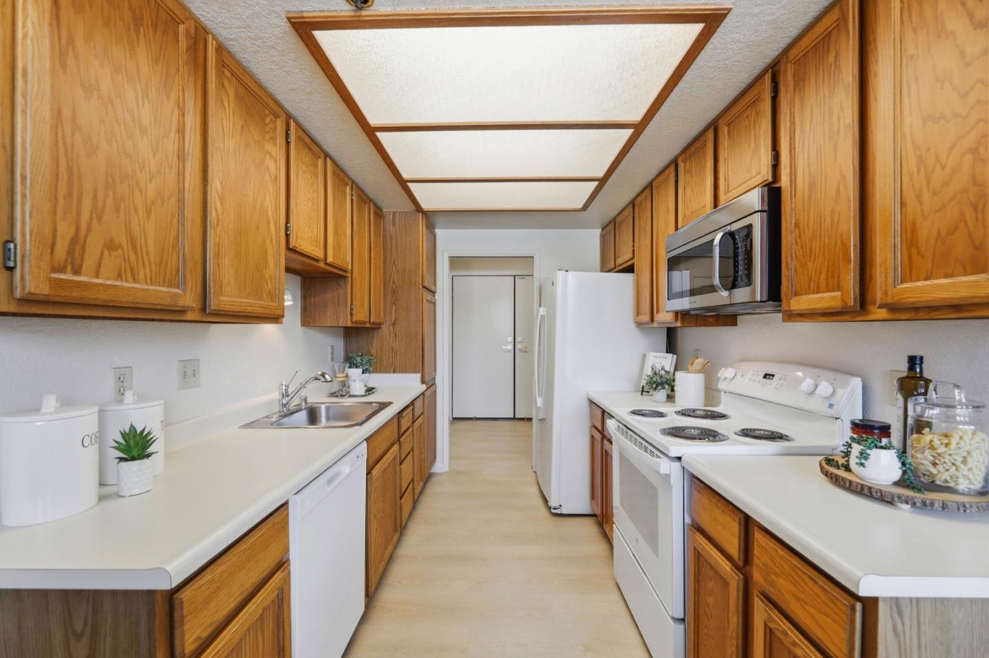 22330 Homestead Road, Unit 226 Cupertino, CA 95014 - Photo 12 of 38 a kitchen with stainless steel appliances granite countertop a sink a stove and a refrigerator