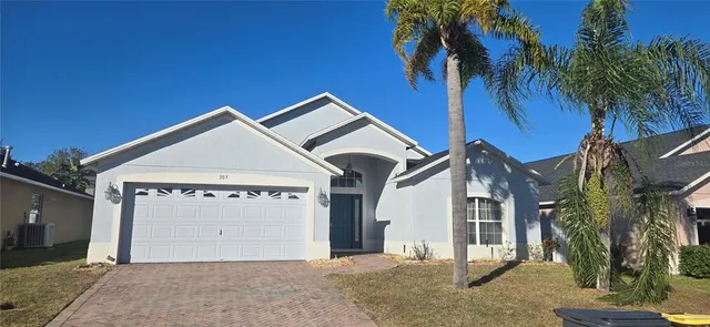 a view of a house with a yard and garage