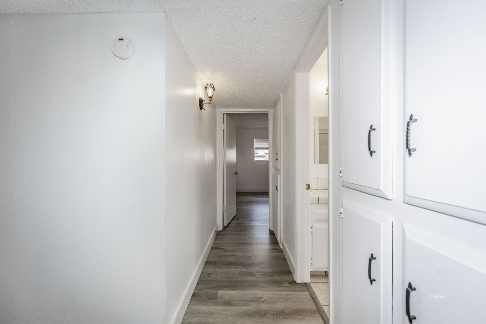 212 Rancho Street Ridgecrest, CA 93555 - Photo 18 of 25 a view of a hallway with a wooden floor