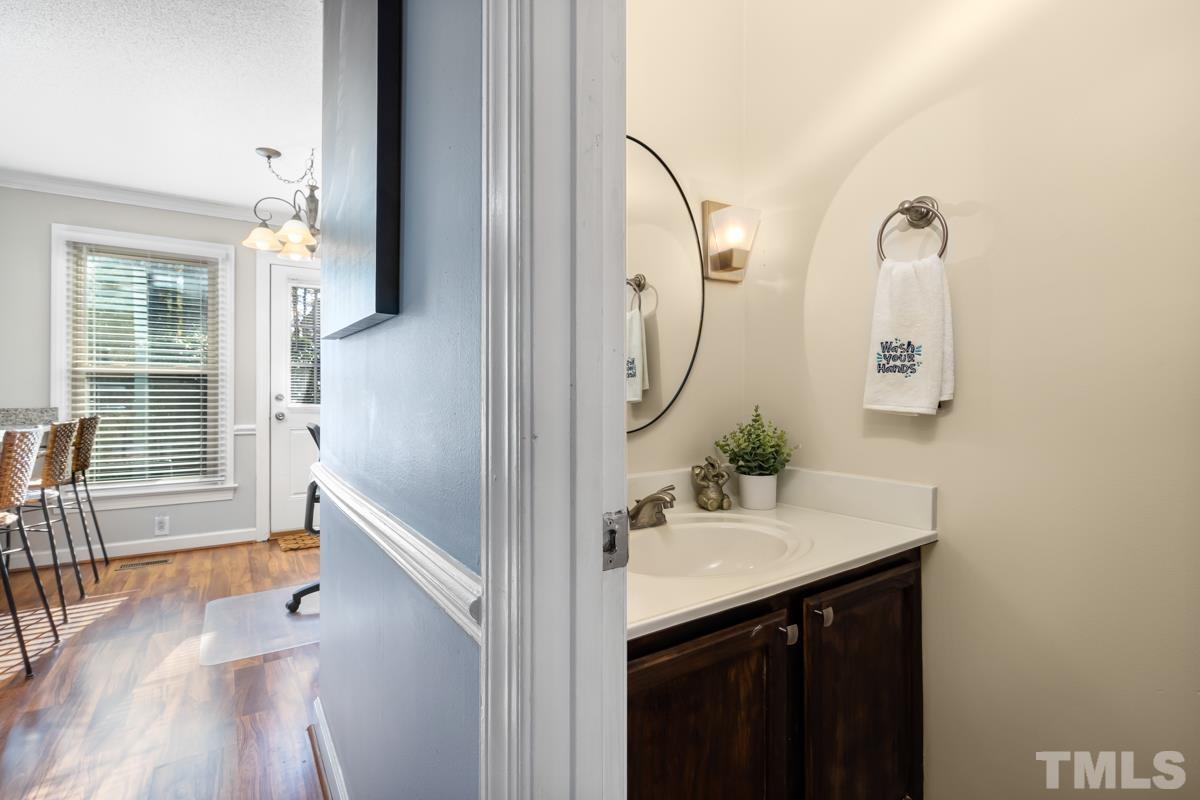 1202 Shadow Bark Court Raleigh, NC 27603 - Photo 17 of 27 a bathroom with a sink and mirror with bathtub