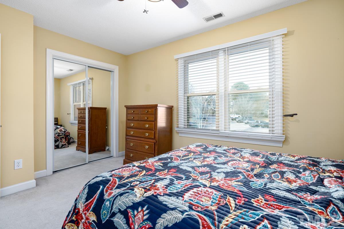 1202 Shadow Bark Court Raleigh, NC 27603 - Photo 19 of 27 a bedroom with a bed and a television