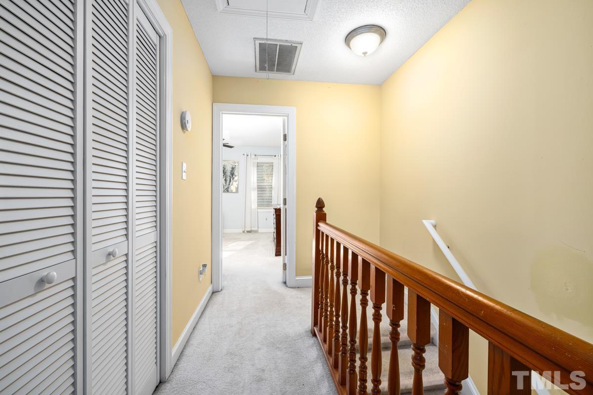 1202 Shadow Bark Court Raleigh, NC 27603 - Photo 22 of 27 a view of a hallway with wooden floor