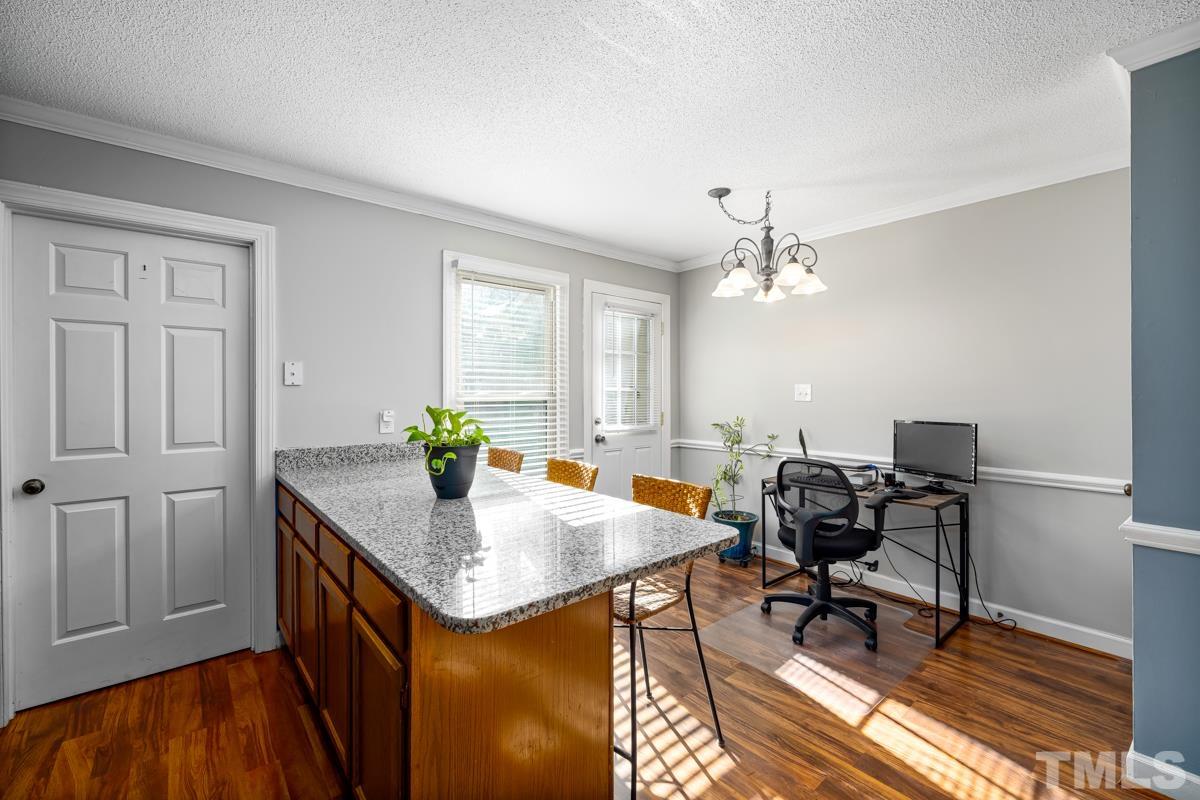 1202 Shadow Bark Court Raleigh, NC 27603 - Photo 10 of 27 a workspace with wooden floor and a window