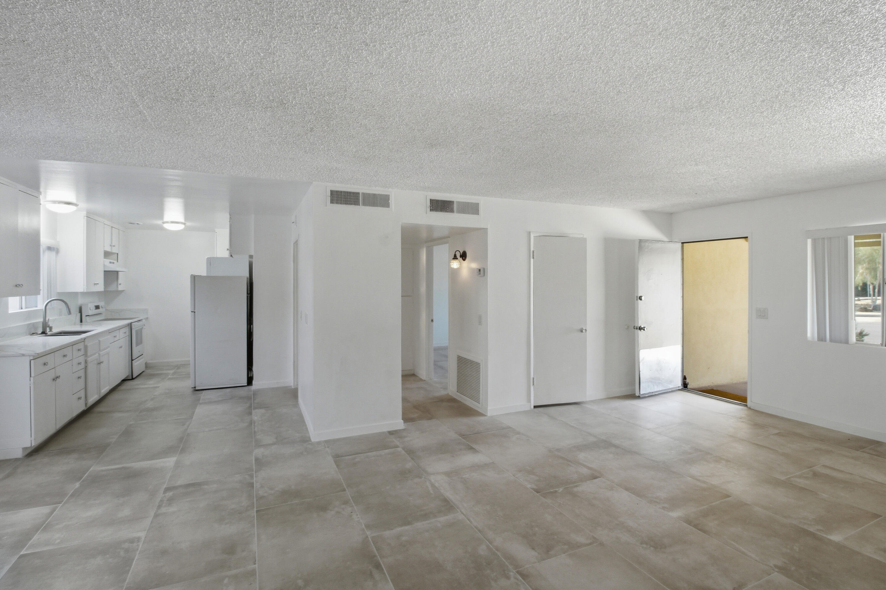 77912 Michigan Drive, Unit A2 Palm Desert, CA 92211 - Photo 6 of 12 a view of a big room with windows and cabinet