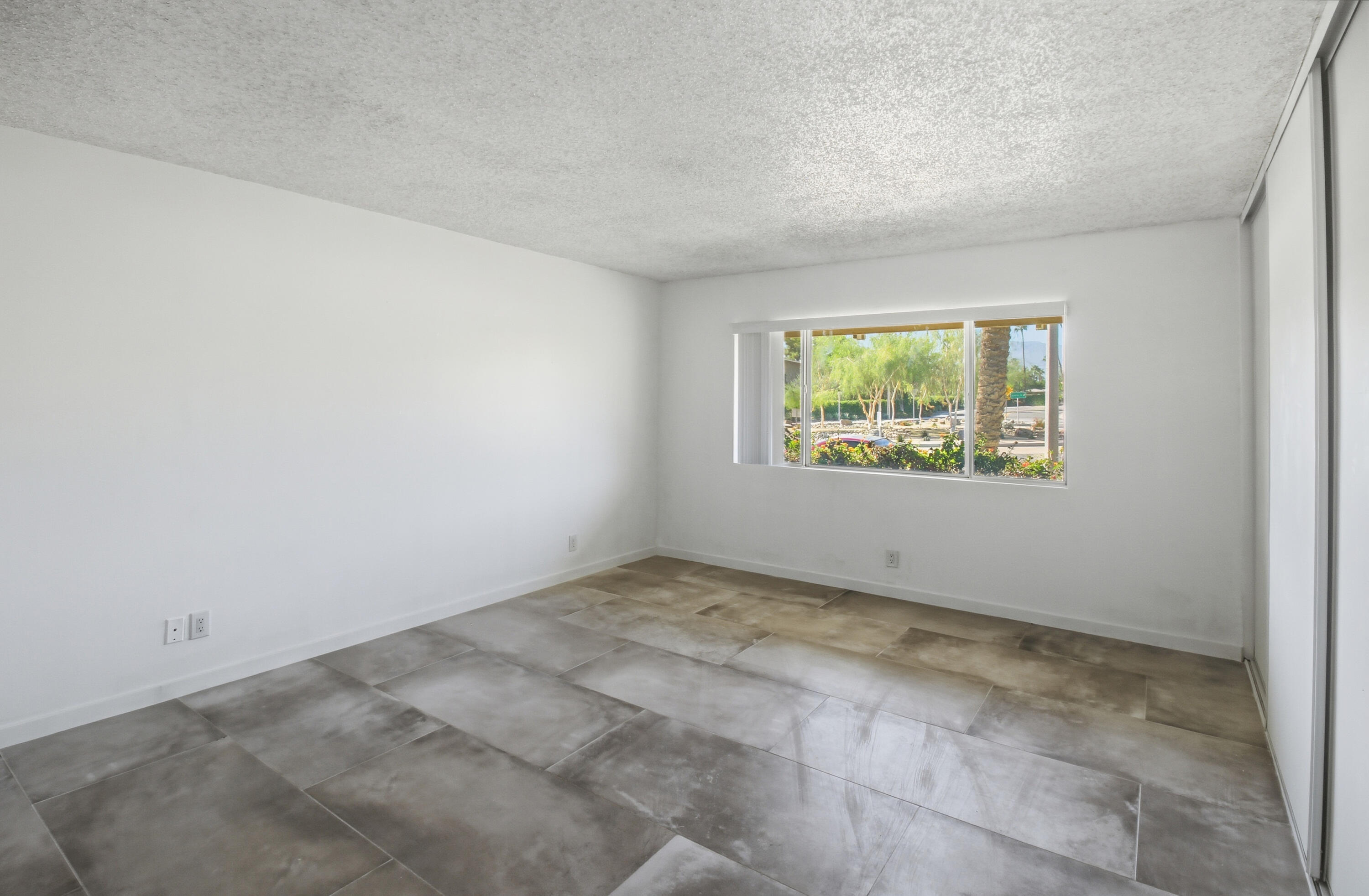 77912 Michigan Drive, Unit A2 Palm Desert, CA 92211 - Photo 10 of 12 an empty room with windows