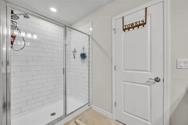 a bathroom with a glass shower door