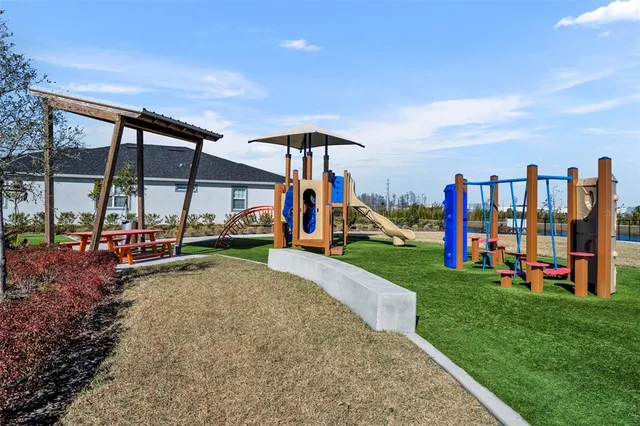 a view of a park with swings and slides