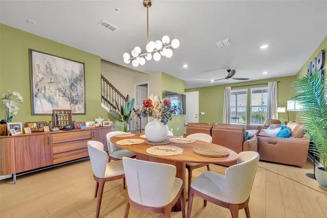a view of a dining room with furniture a livingroom and chandelier