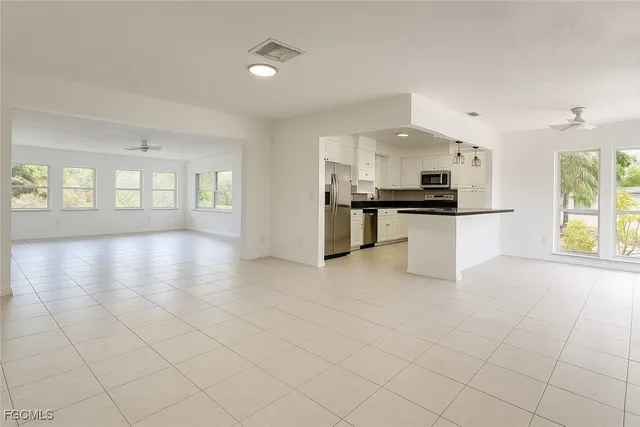 a large white kitchen with cabinets and a stove