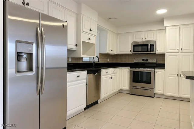 a close view of a refrigerator a sink and cabinets