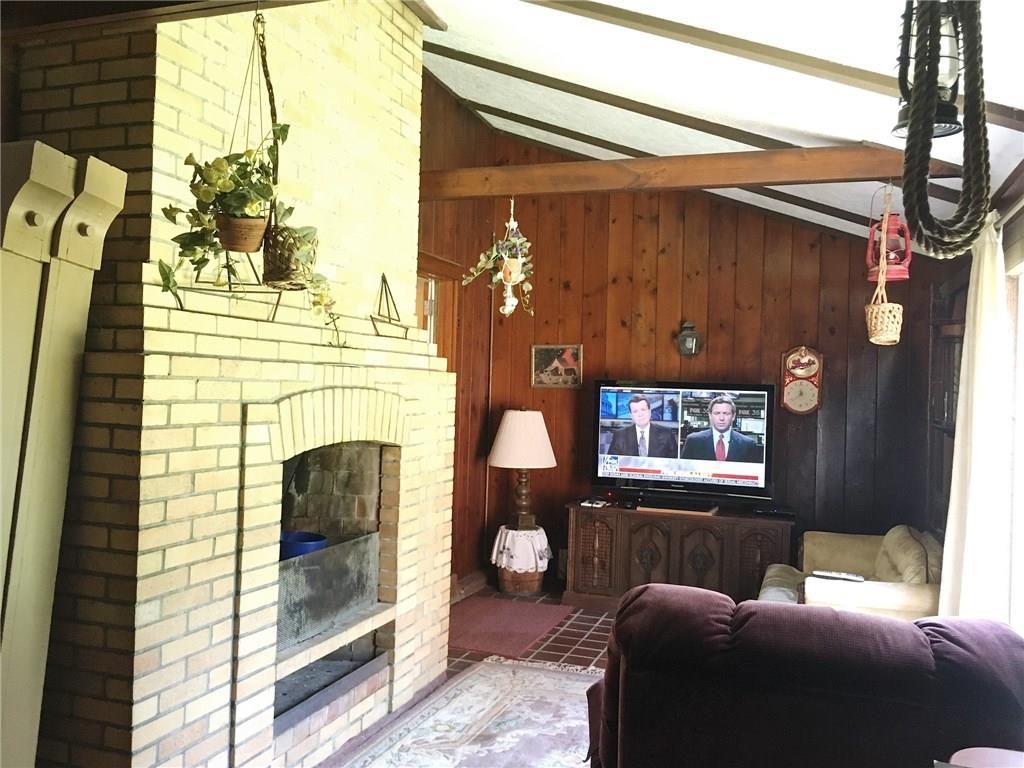 2859 Brodhead Road Aliquippa, PA 15001 - Photo 5 of 23 FAMILY ROOM - Wood burning brick fireplace to curl around on those chilly days. Clay tile floors and cedar panels. Slider to the right is a great place to watch the birds and wildlife.