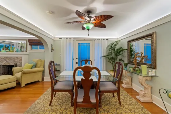 a dining room with furniture a rug and wooden floor