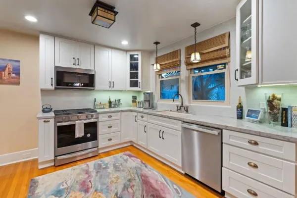 a kitchen with cabinets appliances and a window