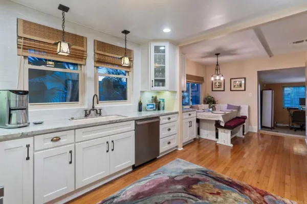 a view of kitchen sink cabinets and wooden floor