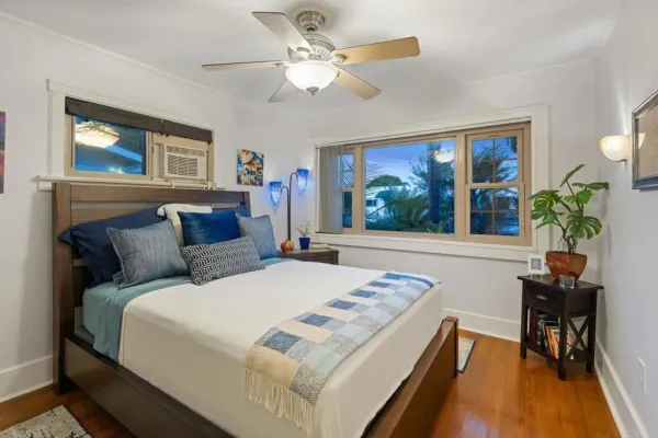 a bedroom with a large bed and a chandelier